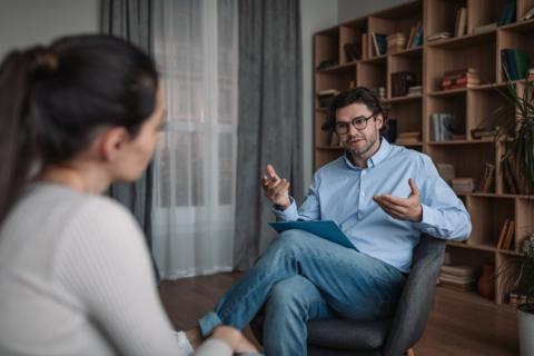 A counselor speaks with a client in an office