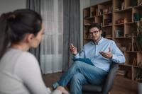 A counselor speaks with a client in an office